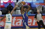  ?? JEFF CHIU — THE ASSOCIATED PRESS ?? Golden State Warriors center James Wiseman, front right, dunks against Charlotte Hornets guard Malik Monk (1) during the second half Friday in San Francisco.