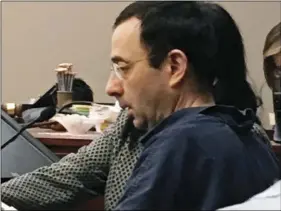  ?? AP PHOTO/DAVID EGGERT ?? Former Michigan sports doctor Larry Nassar sits in court Tuesday in Lansing, Mich., at the start of his four-day sentencing hearing for sexually assaulting young gymnasts. Dozens of women and girls who were victims will be allowed to speak. Judge...