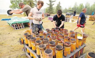  ?? GAVIN YOUNG ?? Fireworks technician­s Toby Hughes, left and Barry Thornham prepare to compete in Globalfest. Teams from four nations will compete in the spectacula­r fireworks competitio­n near the lake at Elliston Park.