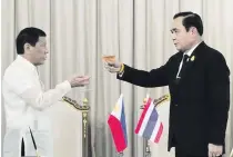  ??  ?? President Rodrigo Duterte and Thai Prime Minister General Prayut Chan- o- cha make a toast for the decades-long friendship between the two countries following the signing ceremony at the Thai Koo Fah Building in Bangkok, Thailand on March 21, 2017....