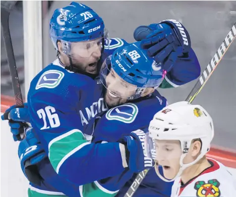  ?? DARRYL DYCK/THE CANADIAN PRESS ?? Vancouver Canucks Thomas Vanek, left, and Sam Gagner had a big night flanking Brock Boeser Thursday night against the Chicago Blackhawks, with Vanek recording five points.