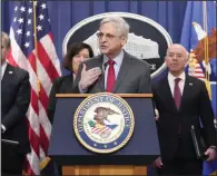  ?? (AP/Mark Schiefelbe­in) ?? Attorney General Merrick Garland (center) speaks with reporters on Wednesday during a news conference at the Department of Justice, in Washington, D.C.