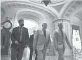  ?? J. SCOTT APPLEWHITE/AP ?? Minority Leader Mitch Mcconnell, R-KY., center, walks to the Senate on Monday as the $1 trillion bipartisan infrastruc­ture package gets closer to passage.