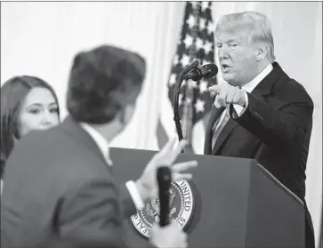  ?? Oliver Contreras TNS ?? PRESIDENT TRUMP and CNN’s Jim Acosta get into a testy exchange on Nov. 7, the day after the midterm election. After the incident, the White House revoked Acosta’s press credential, and CNN then sued.