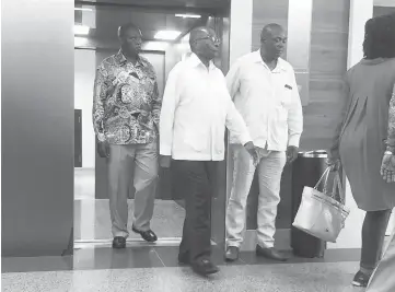  ??  ?? Mugabe walks out of a lift at the Gleneagles Hospital in Singapore. — AFP photo