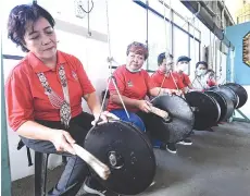  ??  ?? The Warisan Plus candidate cum incumbent for Kepayan seat, Jannie Lasimbang, beating a gong when attending a cultural event at Dewan Kampung Nagasiba, Penampang, yesterday.