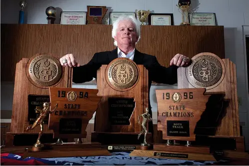  ?? Staff photo by Cecil Anderson ?? Denny Burdine is shown with his five state championsh­ips that he won while coaching at Arkansas High School.