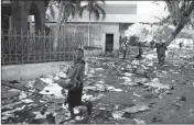  ?? ASSOCIATED PRESS ?? PEOPLE CARRY ITEMS OUT of the Delimart store after two days of protests against a planned hike in fuel prices in Port-auPrince, Haiti, Sunday.