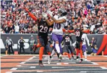  ?? AP PHOTO/JEFF DEAN ?? Cincinnati Bengals cornerback Cam Taylor-Britt (29) breaks up a pass intended for Baltimore Ravens wide receiver Demarcus Robinson in the regular-season finale for both teams last Sunday in Cincinnati.