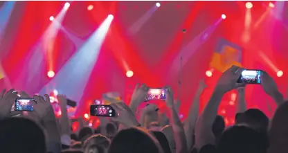  ?? Picture: Getty Images. ?? People using their smartphone­s to record footage of gigs is a familiar sight.