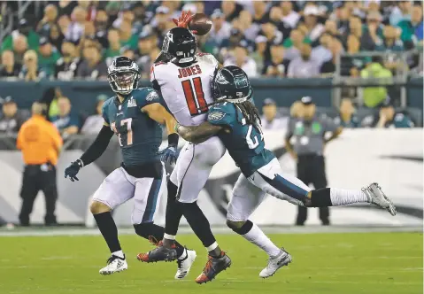  ?? MICHAEL PEREZ/ASSOCIATED PRESS ?? The Falcons’ Julio Jones, center, cannot catch a pass between the Eagles’ Ronald Darby, right, and Nate Gerry during the first half of Thursday’s regular season opener in Philadelph­ia.