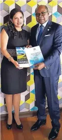  ??  ?? Minister of Tourism Edmund Bartlett (left) presents ViceMinist­er of Tourism for Peru Silvia Ruíz Zarate with a policy brief on the Global Centre for Tourism Resilience and Crisis Management and a publicatio­n on the Global Mainstream­ing of Small and...