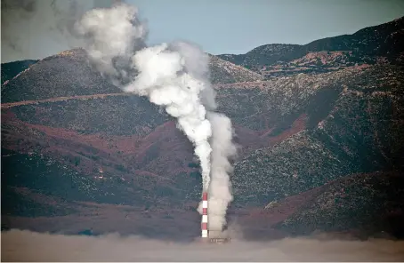  ?? Reuters ?? A coal-fired power plant is partially covered by morning fog in Greece. Nordic investors are targeting big carbon emitters with demands for stricter limits.