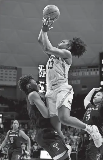  ?? JESSICA HILL/AP PHOTO ?? UConn’s Christyn Williams is fouled by Temple’s Breanna Perry, left, as Williams takes a shot during the second half of the Huskies’ 109-74 win on Saturday at Gampel Pavilion in Storrs.