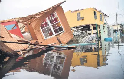  ?? Picture: AFP ?? CALAMITY. A destroyed house in flooded Catano town, Juana Matos, Puerto Rico, on Thursday. Puerto Rico braced for potentiall­y calamitous flash flooding after being pummelled by Hurricane Maria.