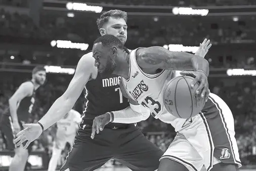  ??  ?? LOS ANGELES Lakers forward LeBron James (23) dribbles as Dallas Mavericks guard Luka Doncic (77) defends during overtime at American Airlines Center. Kevin Jairaj, USA TODAY Sports via Reuters