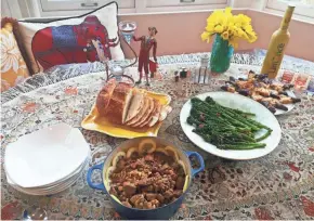  ?? AMY DEWALL DADMUN ?? This almost-spring meal consists of a lamb stew, broccolini, bread and, for dessert, chocolate-dipped Florentine cookies served with limoncello.