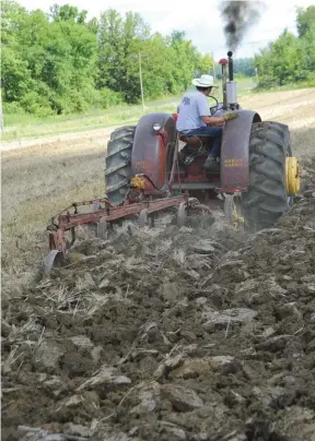  ??  ?? Chris Dauer shows what the old Triple-nickel can do with a four-bottom Massey Harris 4-14 Model 28 plow in very tough NW Ohio clay. The 555 was rated as a “4-5 plow” tractor, but that very inexact period rating depends on the ground conditions, and baked NW Ohio clay is notorious for bringing even the toughest tractors to their knees. The Riceland and Western 555s featured very large tires. Originally the rears were 18-26 but Meyers has upgraded to a 23.1-26, which is more easily available. The original South Dakota owner had the old beast well-weighted and Daren left it that way, with 1,800 pounds on the rear wheels (6x150-pound weights). The tractor was photograph­ed at the 2017 Alvordton Plow Days.