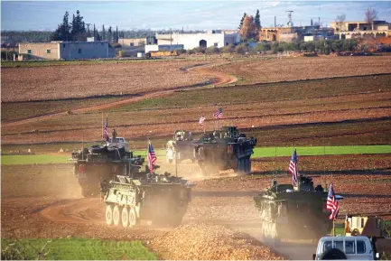  ??  ?? A convoy of US armored vehicles moves near the village of Yalanli, on the western outskirts of the northern Syrian city of Manbij. (AFP)