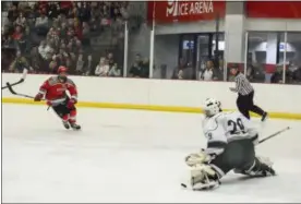  ?? MICHAEL P. PAYNE - FOR THE NEWS-HERALD ?? Lake Catholic goaltender Patrick Kristo makes a pad save against Mentor’s Evan McBride on Dec. 28.