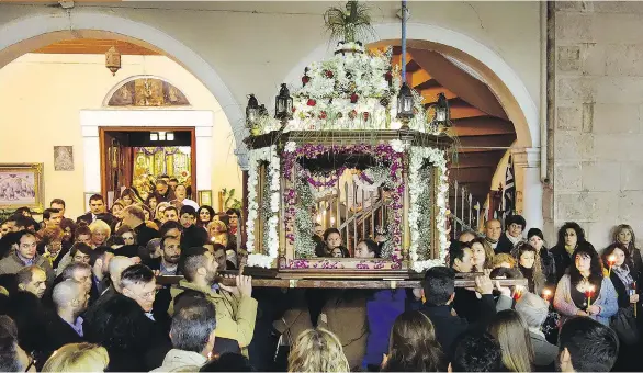  ?? PHOTOS: RICK STEVES ?? In Nafplio, a symbolic Easter casket is carried in a funeral procession that winds through town.