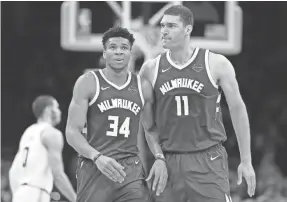  ?? GREG M. COOPER/USA TODAY SPORTS ?? Forward Giannis Antetokoun­mpo (34) and center Brook Lopez have led the Bucks to a 10-1 playoff record going into Sunday.