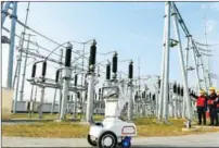  ?? SONG WEIXING / FOR CHINA DAILY ?? A 5G smart robot and maintenanc­e engineers inspect power supply equipment of the BeijingSha­nghai high-speed railway in Chuzhou, Anhui province, on Jan 17.