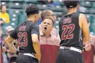  ?? EUGENE TANNER/AP FILE ?? New Mexico State men’s coach Chris Jans shouts instructio­ns to guard Zach Lofton (23) as forward Eli Chuha (22) looks on in the first half of a game Dec. 25.