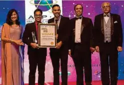  ??  ?? MSC — Asia Pacific ICT Alliance Malaysia 2019 award winners Mohamed Mafaz Mohamed Ahsan, (centre) and Akshey Kumar (second from left) receiving their award from Malaysia Digital Economy Corporatio­n chief executive officer Surina Shukri (left), PIKOM chairman Ganesh Kumar Bangah (second from right) and APICTA chairman Stan Singh-Jit (right).