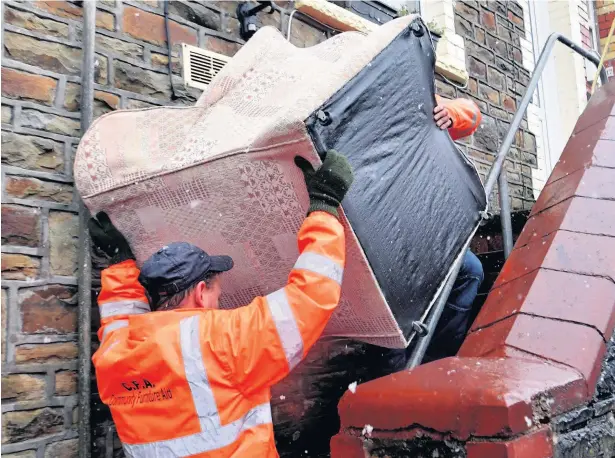  ?? JONATHAN MYERS ?? Members of Community Furniture Aid delivering furniture to a property on Nant-yr-Ychain Terrace, Bridgend. Below, Julian and Marianne Cash