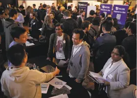  ?? Carlos Avila Gonzalez / The Chronicle ?? Several hundred people pack the Blockchain Career Fair at UC Berkeley.