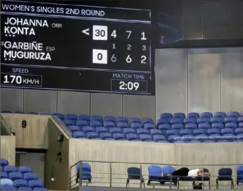  ?? Associated Press ?? A spectator, lower right, sleeps at Margaret Court Arena in Melbourne, Australia, even as the decisive third set between Garbine Muguruza and Johanna Konta plays itself out in front of her. The fan should be forgiven. It was pushing 3 a.m. as the players traded serves and volleys.