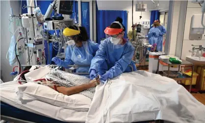  ?? Photograph: Neil Hall - Pool/Getty Images/ Getty Images ?? Clinical staff care for a patient at the intensive care unit at Royal Papworth hospital in May.