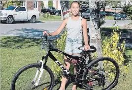  ??  ?? After 12-year-old Cassie Sauve’s bike was stolen, her mom posted a notice about it on Facebook. Fellow Caledonia resident Russ Savage saw the post and bought Cassie a new bike.