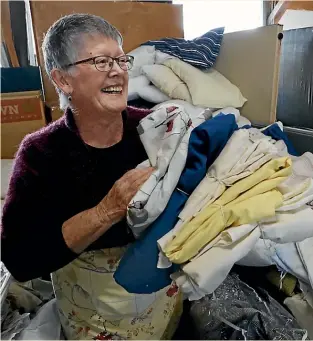  ?? MARTIN DE RUYTER/STUFF ?? Rachel Chapman-Munro sorts linen at Nelson’s ReStore. A pile of donated sheets hid a bag of money being stored away by a man, unbeknown to his wife who donated the linen.