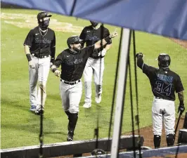  ?? FRANK FRANKLIN II AP ?? Francisco Cervelli celebrates with teammates after hitting a three-run home run during the second inning that provided most of the offense needed in the Marlins’ 4-3 win.