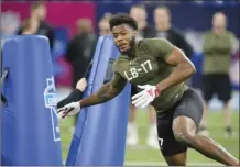  ?? AP photo ?? Nebraska linebacker Ochaun Mathis runs a drill at the NFL football scouting combine in Indianapol­is on Thursday.