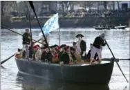  ?? THE ASSOCIATED PRESS ?? John Godzieba, as Gen. George Washington, second right, stands in a boat Dec. 25, 2016, during a re-enactment of Washington’s daring Christmas 1776 crossing of the Delaware River in Washington Crossing, Pa.