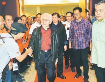  ??  ?? Taib shakes hands with a biker upon his arrival at the gala dinner. Abang Johari is behind Taib while Abdul Karim is at second right. — Photos by Muhammad Rais Sanusi