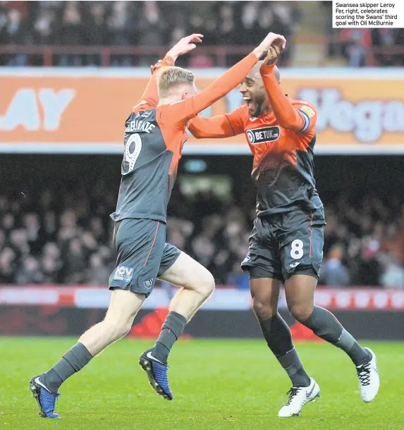  ??  ?? Swansea skipper Leroy Fer, right, celebrates scoring the Swans’ third goal with Oli McBurnie