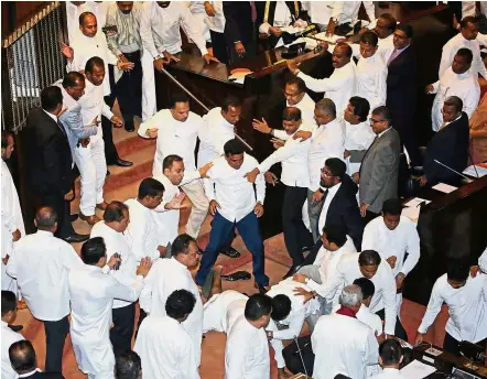  ?? — Reuters ?? In the thick of it: Sri Lankan lawmakers fighting during the parliament session in Colombo.