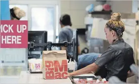  ?? BLOOMBERG FILE PHOTO ?? An employee packs an order for a customer at a McDonald's restaurant in Phoenix, Ariz.