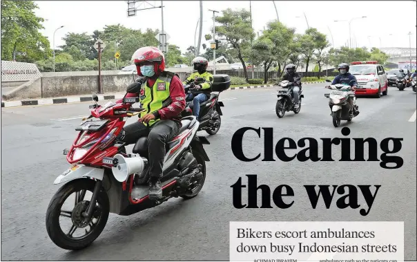  ??  ?? Motorcycle volunteers escort an ambulance carrying the body of a covid-19 victim on its way to a cemetery for burial on July 11 in Bekasi on the outskirts of Jakarta, Indonesia.
(AP/Achmad Ibrahim)