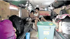  ?? —AFP ?? ‘SOMETIMES... WE DON’T EAT AT ALL’ Jeepney driver Daniel Flores with his daughter.