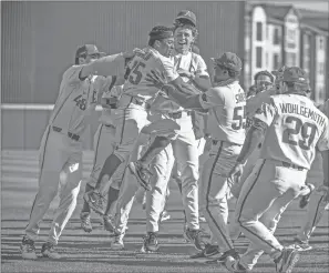  ?? CRAVEN WHITLOW/NATE Allen Sports Service ?? Razorbacks celebrate a walk-off game-winning hit in the bottom of the 10th by outfielder Christian Franklin, 25, against Auburn Saturday afternoon at Baum-walker Stadium in Fayettevil­le.