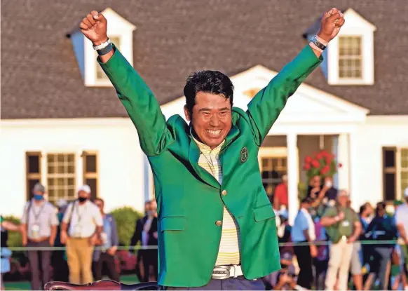  ?? ROB SCHUMACHER/USA TODAY SPORTS ?? Hideki Matsuyama celebrates with the green jacket after finally winning the Masters on Sunday despite a last-hole bogey.