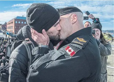  ?? CPL. BRENT KENNY THE CANADIAN PRESS ?? This photo of Master Seaman Francis Legare sharing the traditiona­l “first kiss” with partner Corey made a splash on the Canadian Forces Twitter account.