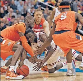  ?? | ROB CARR~GETTY IMAGES ?? Syracuse’s Baye Keita (left), Brandon Triche and C.J. Fair battle with Indiana’s Victor Oladipo for a loose ball Thursday night.