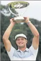  ?? MEL EVANS — AP ?? Bryson DeChambeau hoists the Northern Trust trophy after his four-shot victory.