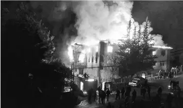  ??  ?? Firemen try to extinguish flames rising from a fire in a school dormitory in Aladag, in the southern city of Adana, Turkey. — Reuters photo